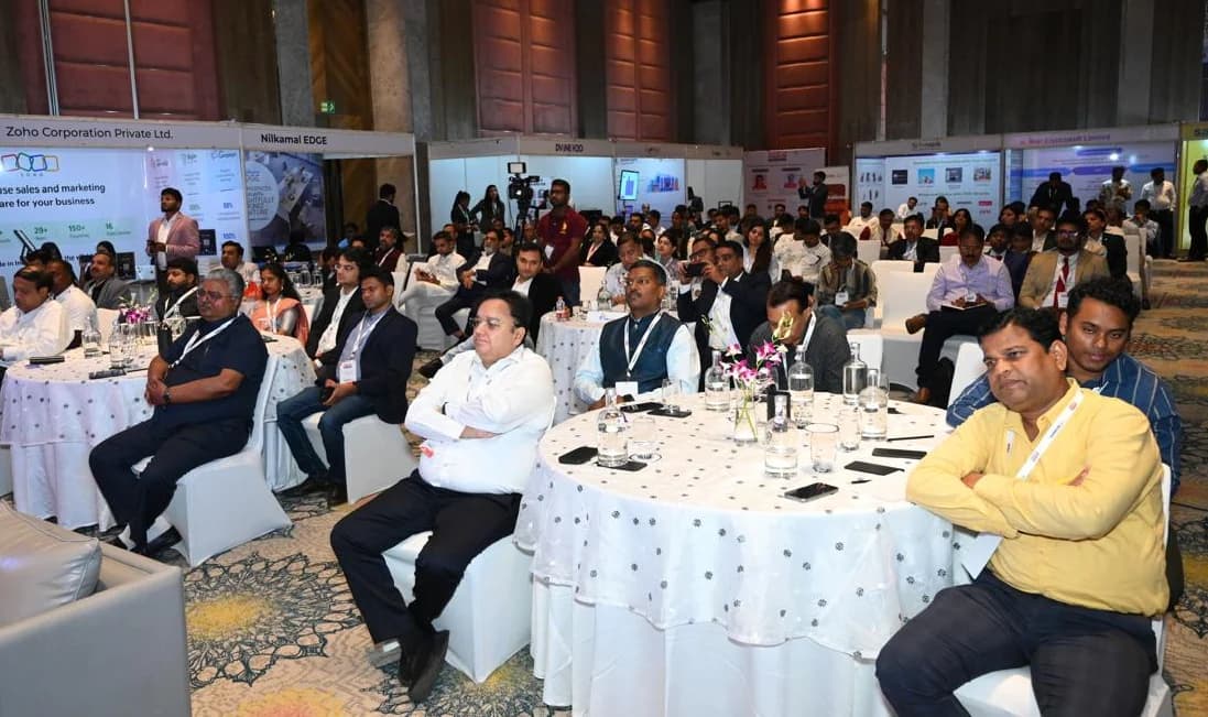 Delegates seated at round tables during a Summentor Pro summit.