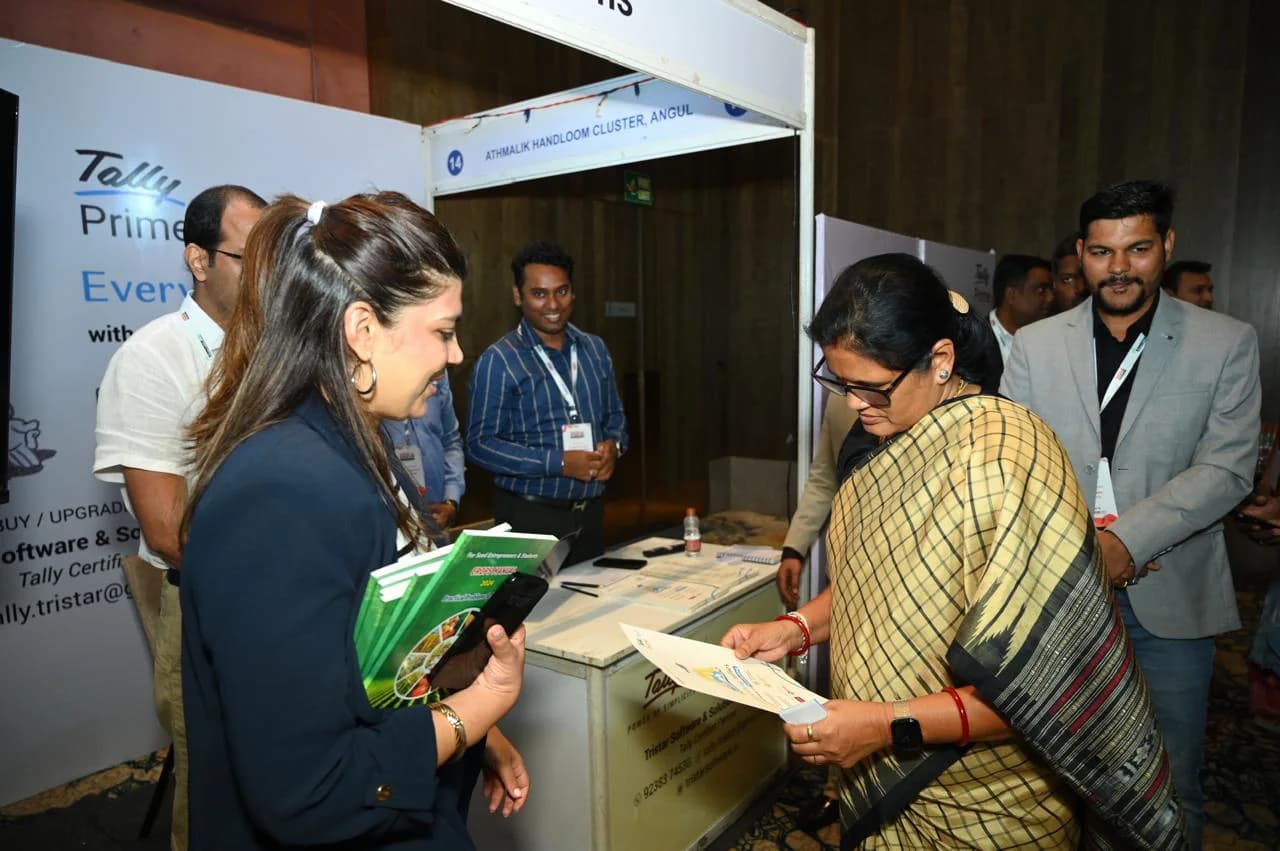 Delegates looking through material at an exhibition stand at a previous edition of the summit.