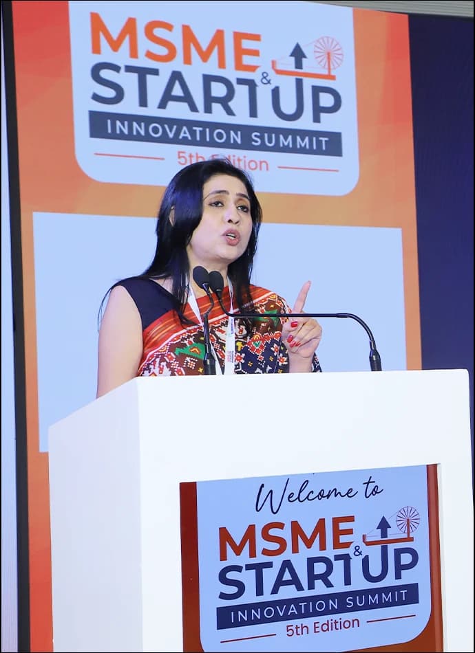 A speaker addressing a previous edition of the summit from the podium.