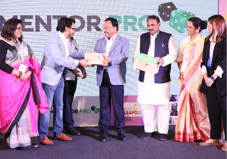 Dignitaries presenting a #Time2Leap Award on stage.