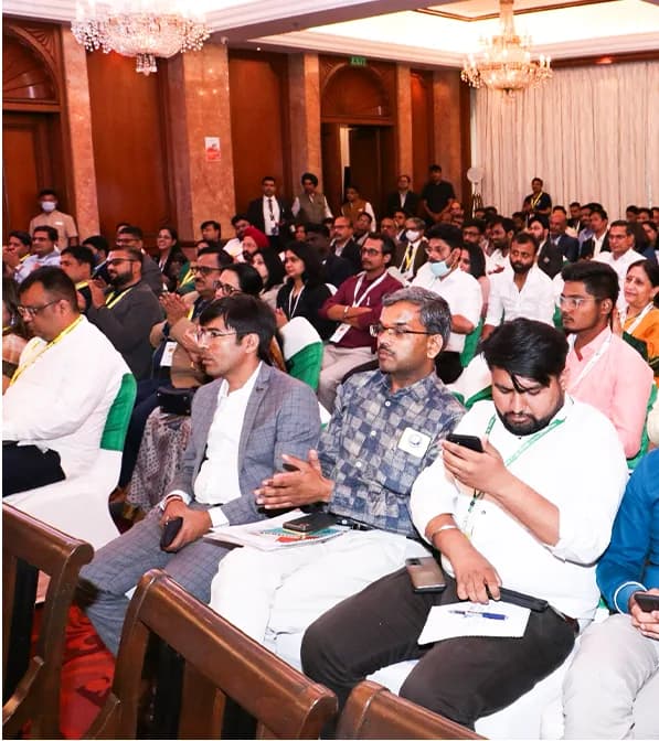 Delegates seated in the audience during a session.