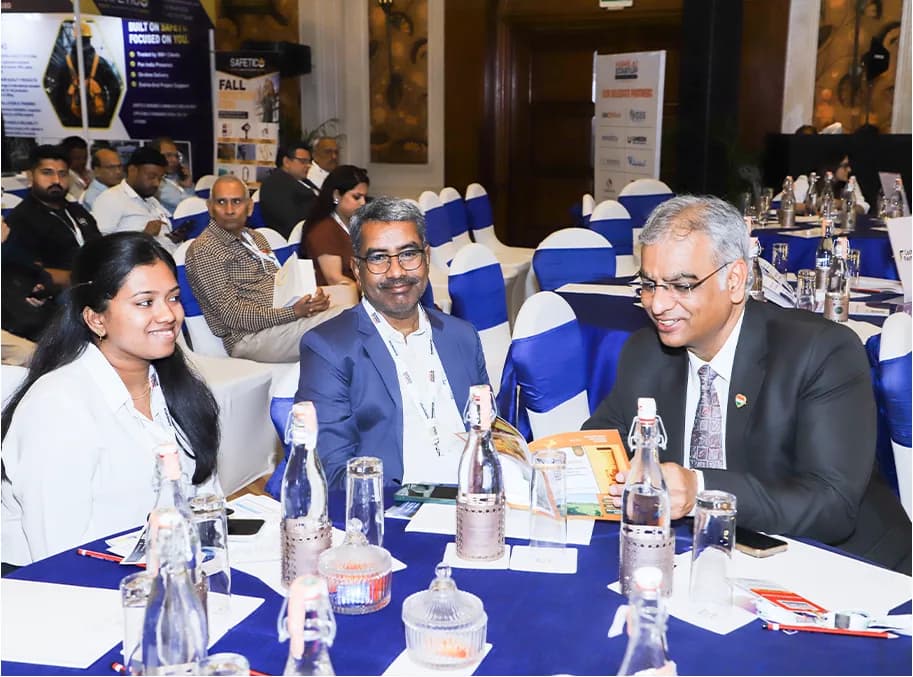 Delegates seated at round tables during a networking session.