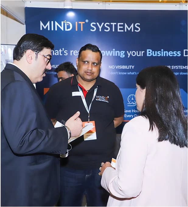 Delegates in conversation at an exhibitor's stall.