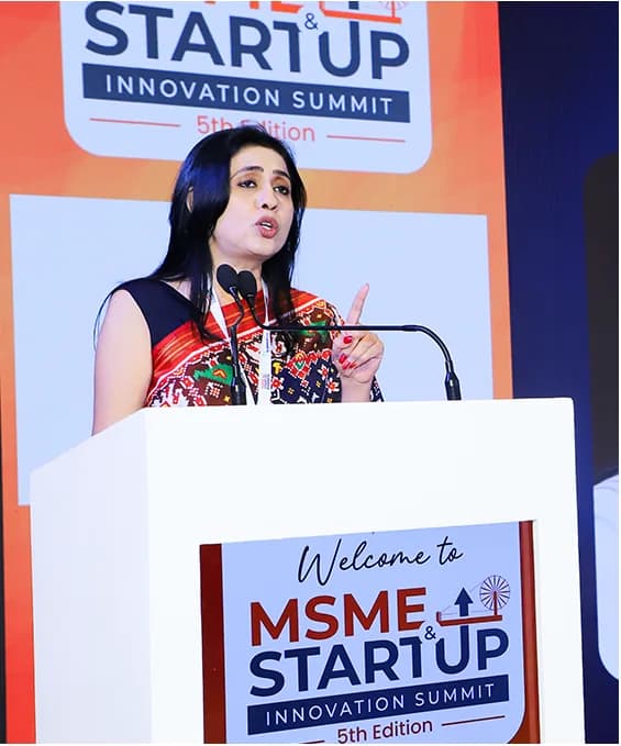 A speaker addressing delegates from the podium at the summit's opening.