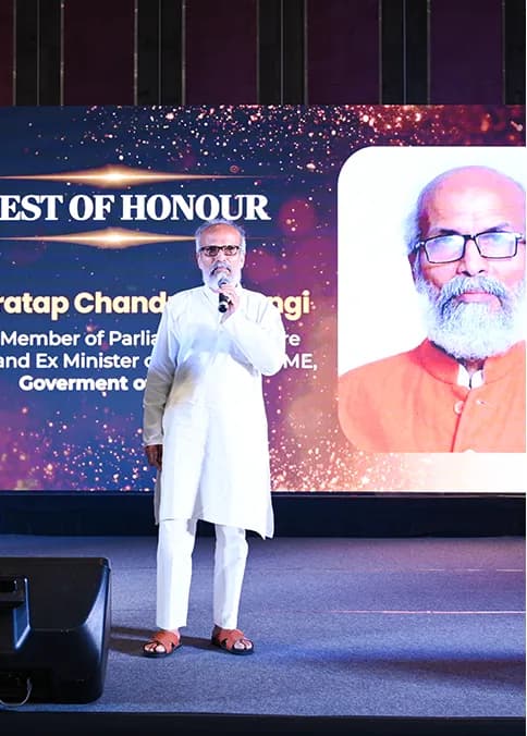 A speaker introduced as Guest of Honour at the podium.